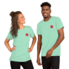 A smiling man and woman wearing matching mint green t-shirts with red rose logos.