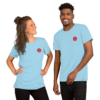 Two people wearing light blue t-shirts with a red rose logo.